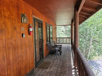 a porch of a cabin with a fire hydrant on it at Cabin 20- King Cabin w Roku TV Full Kitchen in Estes Park