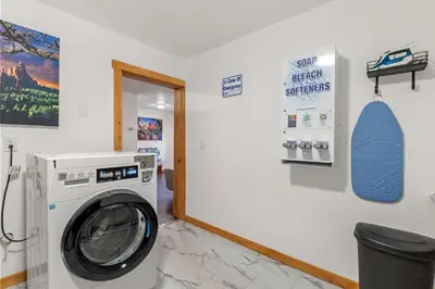 a laundry room with a washing machine in a room at Cabin 21- Accessible Unit & King Bed in Estes Park