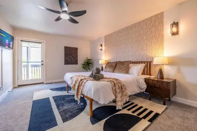 a bedroom with a large bed and a ceiling fan at Hot Tub w Mountain View in Westminster