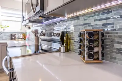a kitchen with a counter with wine bottles on it at Hot Tub w Mountain View in Westminster