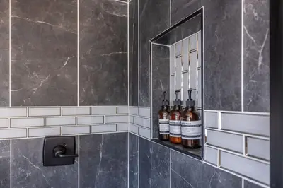 a bathroom with bottles of wine sitting on a shelf at Hot Tub w Mountain View in Westminster