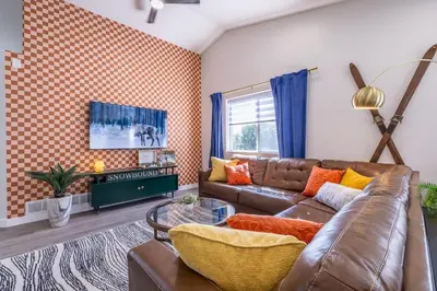 a living room with a couch and a table at Hot Tub w Mountain View in Westminster