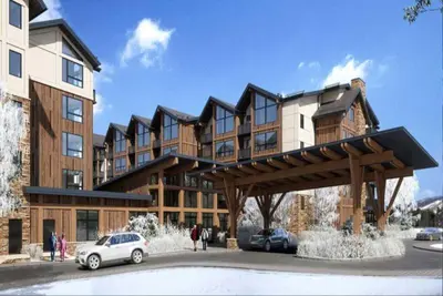 a large building with a car parked in front of it at Kindred Resort Luxury Ski In, Ski Out 3 Bedroom Residence At The River Run Gondola in Dillon