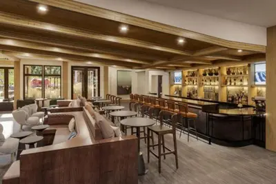a restaurant with tables and chairs and a bar at Kindred Resort Luxury Ski In, Ski Out 3 Bedroom Residence At The River Run Gondola in Dillon