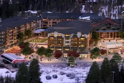 a large building with a courtyard in the snow at Kindred Resort Luxury Ski In, Ski Out 3 Bedroom Residence At The River Run Gondola in Dillon