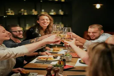 a group of people sitting around a table drinking wine glasses at Kindred Resort Luxury Ski In, Ski Out 3 Bedroom Residence At The River Run Gondola in Dillon