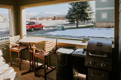 a kitchen with a stove and a table and chairs at Mountain Escape in Fraser near Winter Park Trails in Fraser