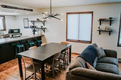a living room with a table and a couch at Mountain Escape in Fraser near Winter Park Trails in Fraser