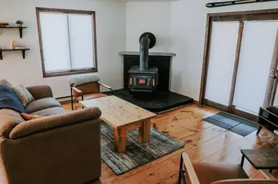 a living room with a wood stove in a room at Mountain Escape in Fraser near Winter Park Trails in Fraser
