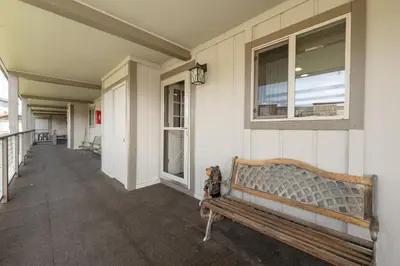 a bench sitting on the side of a building at Winter Park Condo with Fireplace, Centrally Located in Winter Park