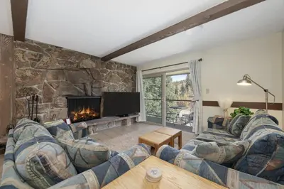 a living room with a couch and a fireplace at Winter Park Condo with Fireplace, Centrally Located in Winter Park