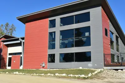 a red and white building with large windows at Winter Park Condo with Fireplace, Centrally Located in Winter Park