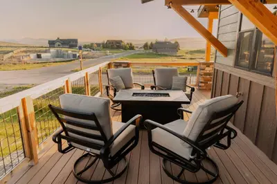 a porch with four chairs and a table on a deck at Ski Granby Ranch five minutes from the house in Granby