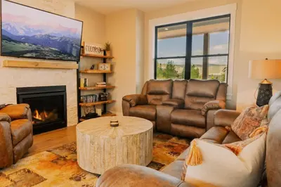 a living room with leather furniture and a fireplace at Ski Granby Ranch five minutes from the house in Granby