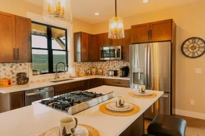 a kitchen with a stove and a counter top at Ski Granby Ranch five minutes from the house in Granby