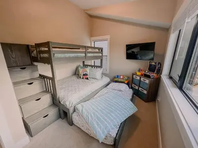 a bedroom with two bunk beds and a desk at Ski Granby Ranch five minutes from the house in Granby