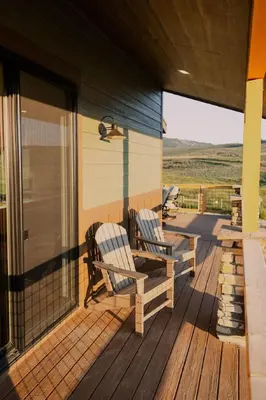 two chairs on the porch of a house at Ski Granby Ranch five minutes from the house in Granby