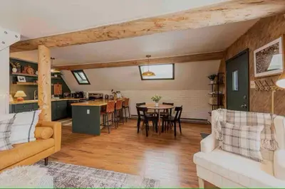 a living room with a couch and a table at Rocky Mountain A Frame in Grand Lake