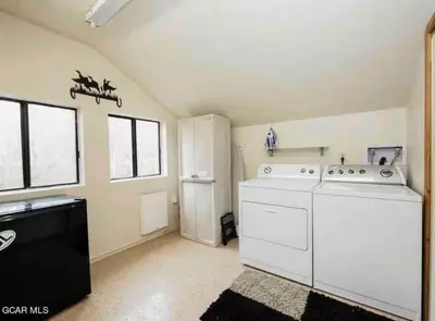 a laundry room with a washer and dryer at Rocky Mountain A Frame in Grand Lake