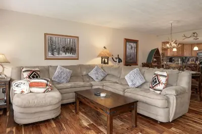 a living room with a couch and a table at Luxury Lake Condo Walk to Downtown in Grand Lake
