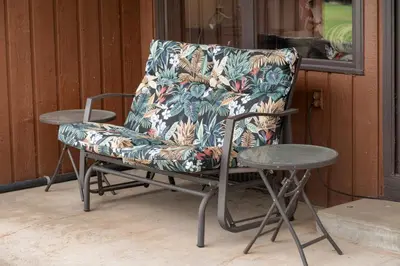 a chair and a table next to a window at Luxury Lake Condo Walk to Downtown in Grand Lake