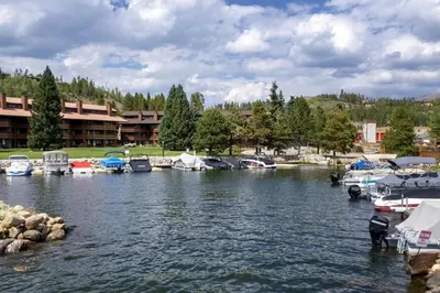 a bunch of boats are docked in a river at Luxury Lake Condo Walk to Downtown in Grand Lake