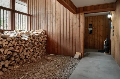 a pile of wood in a room with a wall at Luxury Lake Condo Walk to Downtown in Grand Lake