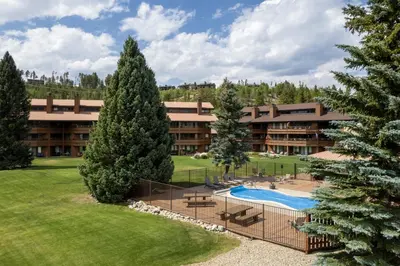 an aerial view of a resort with a pool and trees at Luxury Lake Condo Walk to Downtown in Grand Lake