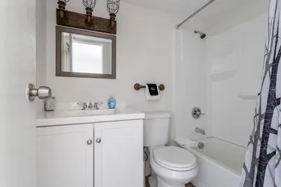 a white bathroom with a toilet and a sink at Charming 2BR Fraser Escape Fireplace Trails Resort Nearby in Fraser