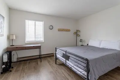 a bedroom with a bed and a desk and a window at Charming 2BR Fraser Escape Fireplace Trails Resort Nearby in Fraser
