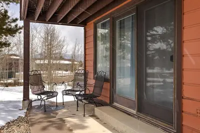 a group of chairs sitting on the front porch of a house at Charming 2BR Fraser Escape Fireplace Trails Resort Nearby in Fraser