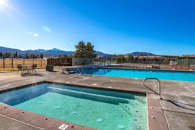 a swimming pool with a view of the mountains at Charming 2BR Fraser Escape Fireplace Trails Resort Nearby in Fraser