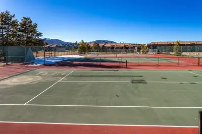 a tennis court with two tennis courts at Charming 2BR Fraser Escape Fireplace Trails Resort Nearby in Fraser
