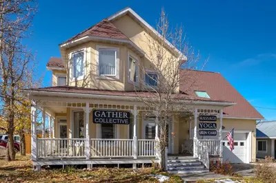 a house with a sign for a garden collective at Charming 2BR Fraser Escape Fireplace Trails Resort Nearby in Fraser