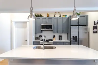 a kitchen with a white counter top and a sink at Eagle Nest on Grand Ave in Grand Lake