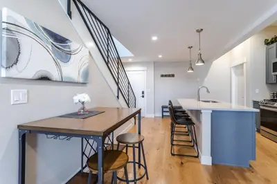 a kitchen and living room with a table and chairs at Eagle Nest on Grand Ave in Grand Lake