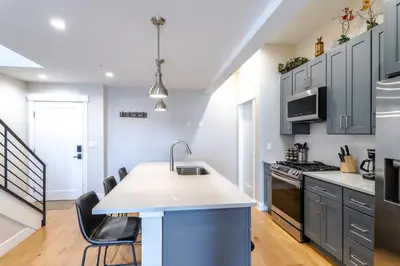 a kitchen with blue cabinets and a kitchen island at Eagle Nest on Grand Ave in Grand Lake