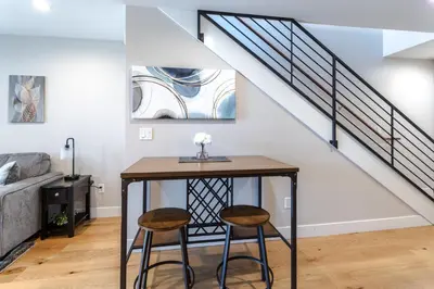 a living room with a table and two stools at Eagle Nest on Grand Ave in Grand Lake