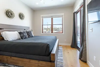 a bedroom with a bed and a window at Eagle Nest on Grand Ave in Grand Lake