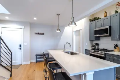 a kitchen with blue cabinets and a white counter top at Eagle Nest on Grand Ave in Grand Lake
