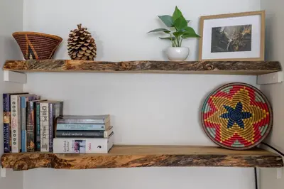 a wooden shelf with books and a bowl on it at Cute modern 2 bed retreat, a perfect basecamp in Fraser