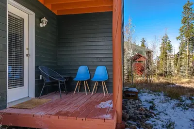two blue chairs and a table on a porch at Cute modern 2 bed retreat, a perfect basecamp in Fraser