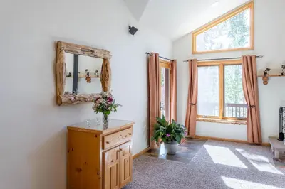 a room with a mirror and a wooden dresser at Spacious Pet-Friendly Grand Lake House in Grand Lake
