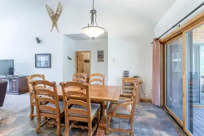 a dining room with a wooden table and chairs at Spacious Pet-Friendly Grand Lake House in Grand Lake