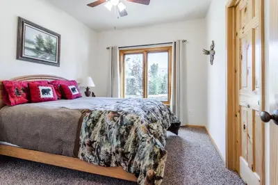 a bedroom with a bed and a window at Spacious Pet-Friendly Grand Lake House in Grand Lake