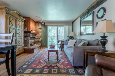 a living room with a couch and a table at Winter Park Mountain Retreat with Stunning Views in Winter Park