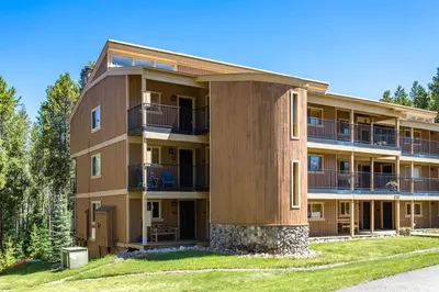a large apartment building with balconies and trees at Winter Park Mountain Retreat with Stunning Views in Winter Park