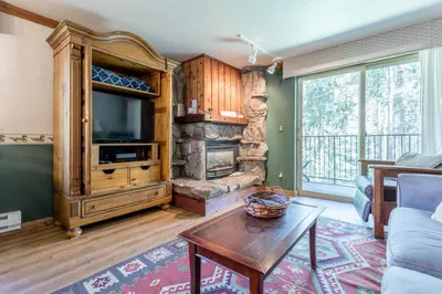 a living room with a tv and a fireplace at Winter Park Mountain Retreat with Stunning Views in Winter Park