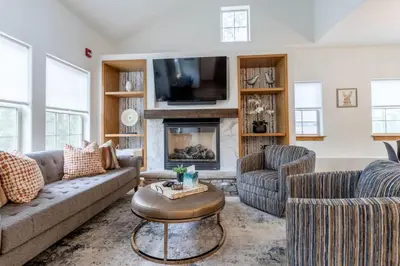 a living room with a couch and a fireplace at 3 BR Fraser Apartment in Fraser