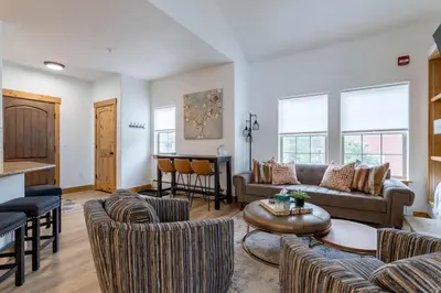 a living room with a couch and chairs and a table at 3 BR Fraser Apartment in Fraser